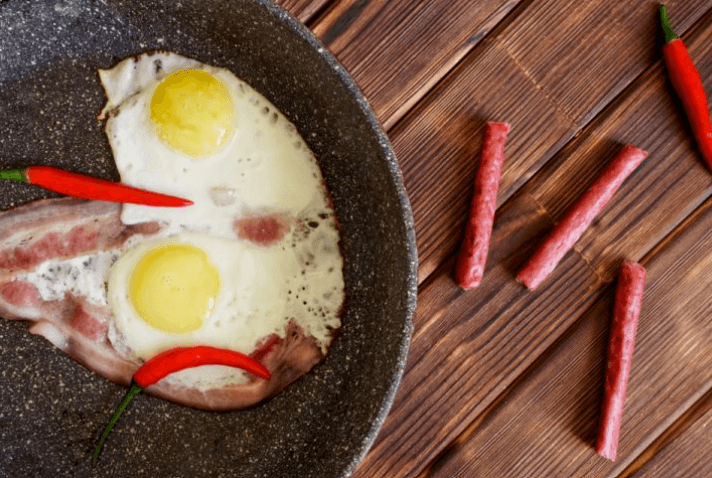 granitewarecomparewithceramic a corner of granite pan contains egg and bacon